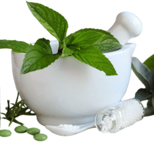 White mortar and pestle with fresh green herbs.