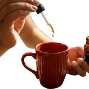 Person using a dropper to add liquid into a red mug.