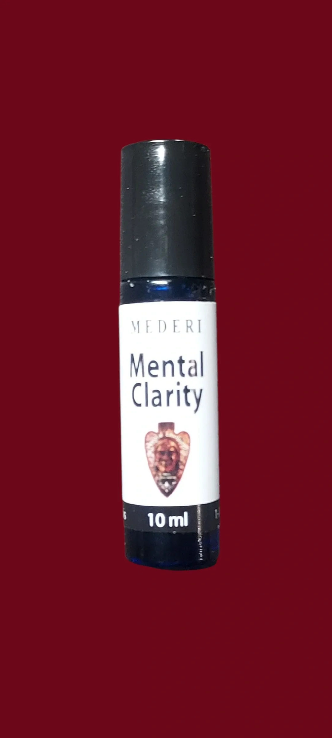 A 10 ml roller bottle labeled 'Mental Clarity' by Mediri.